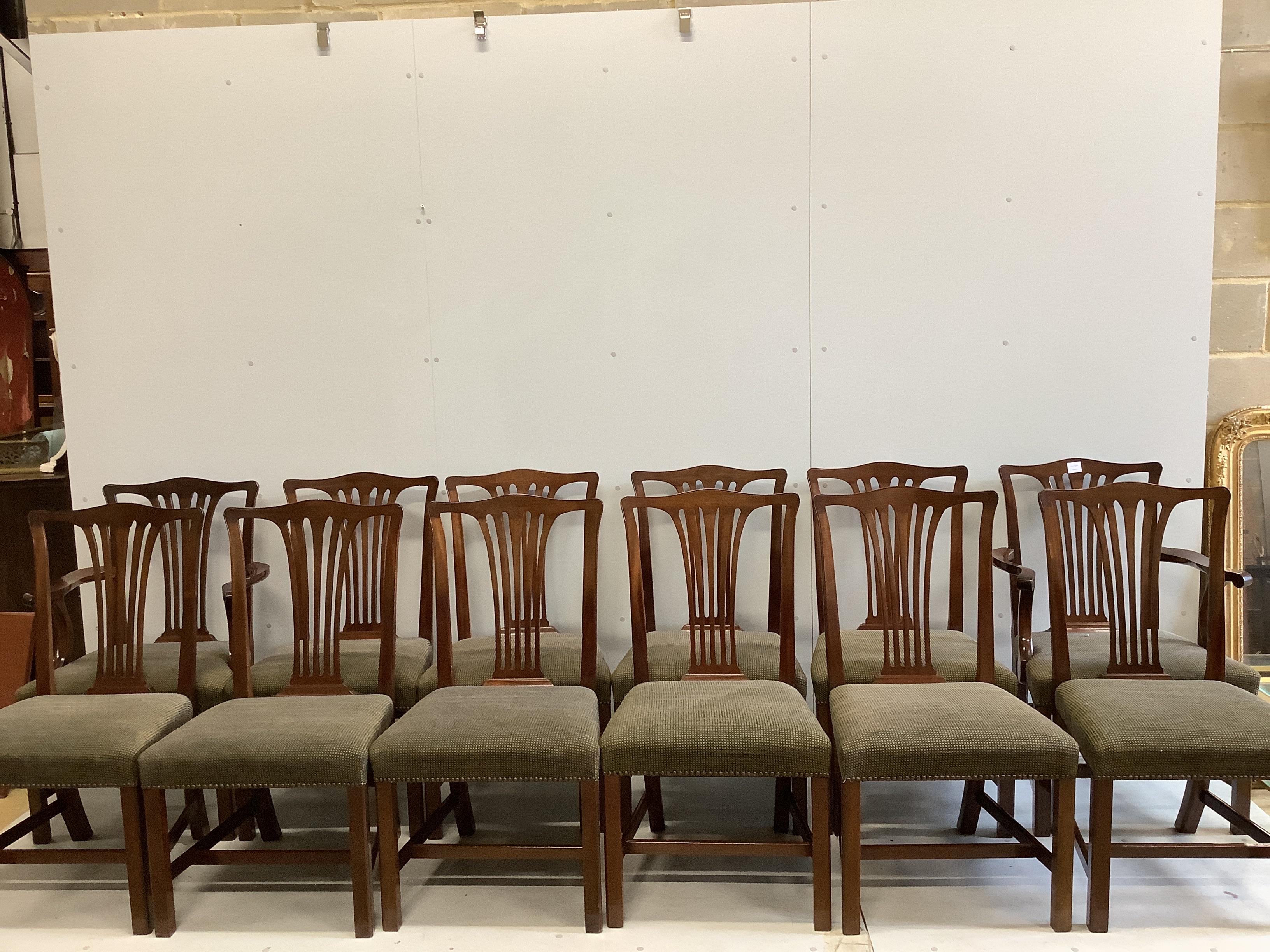 A set of twelve reproduction George III style mahogany dining chairs, ten single, two elbow chairs